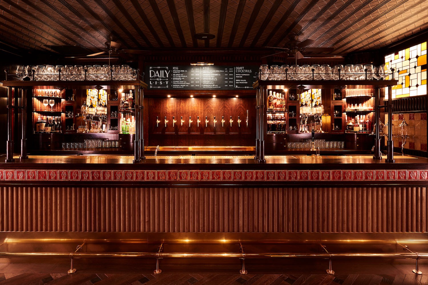 Brigadiers Tap Room bar with brass rail under Bloomberg Arcade
